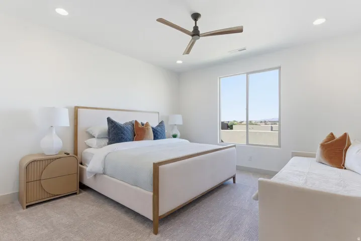 Carpeted bedroom featuring a ceiling fan and recessed lighting