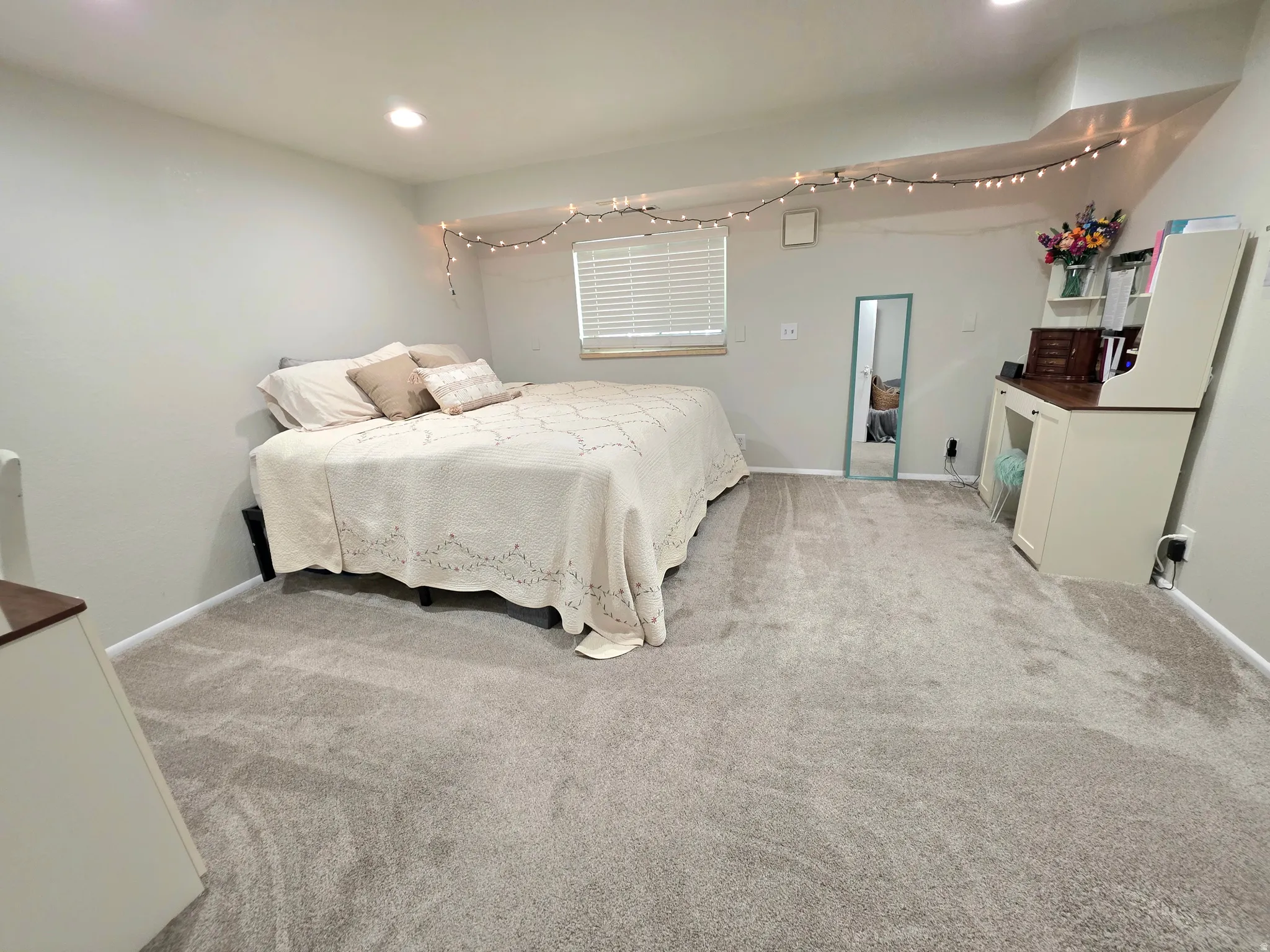 Bedroom with light carpet and recessed lighting
