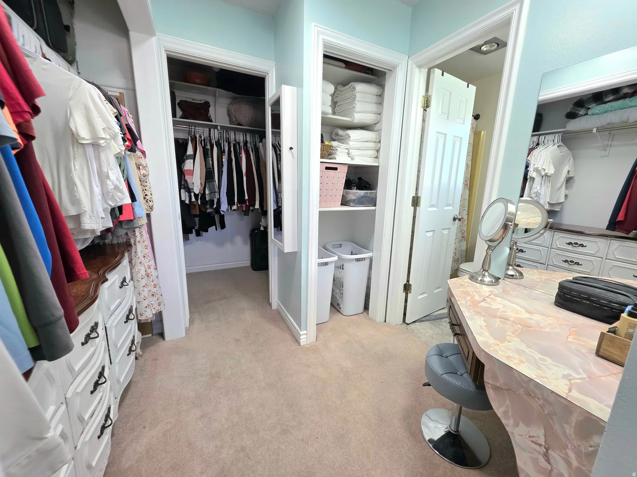 Spacious closet with light colored carpet