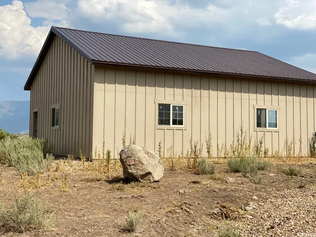 View of home's exterior featuring board and batten siding and a metal roof
