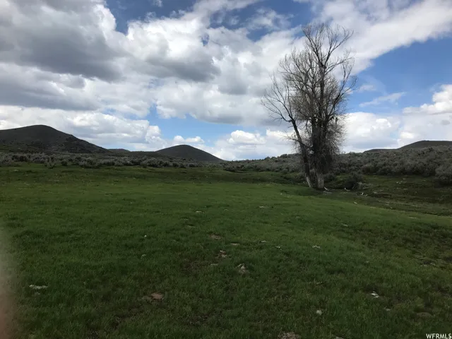 View of mountain backdrop featuring rural landscape