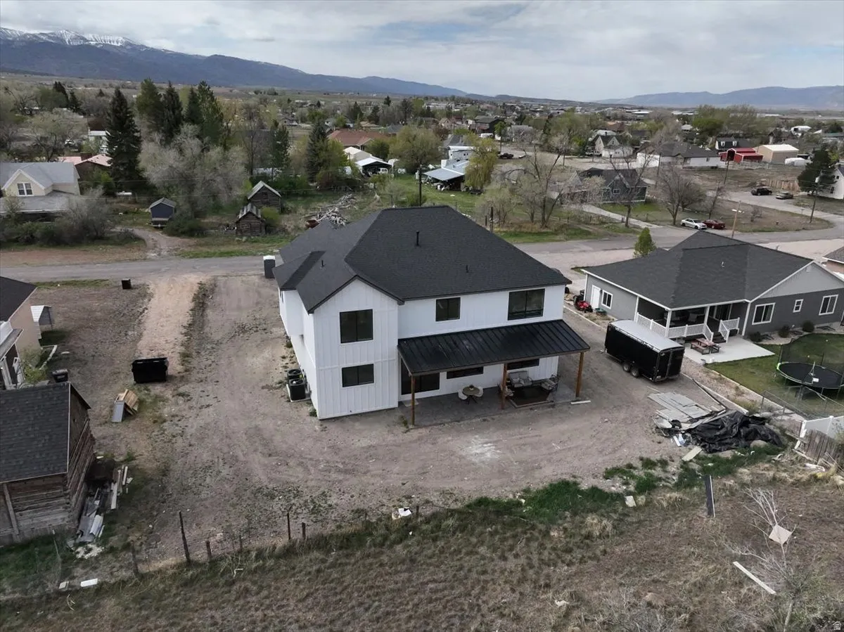 Aerial perspective of suburban area featuring a mountain backdrop