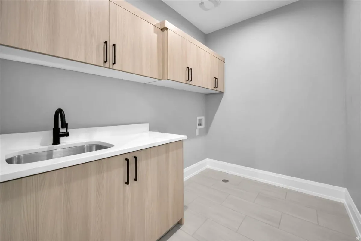 Laundry room with hookup for a washing machine and cabinet space