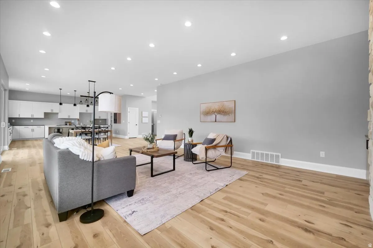 Living room with recessed lighting and light wood finished floors