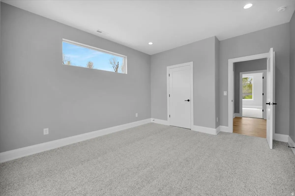 Unfurnished bedroom featuring light colored carpet and recessed lighting