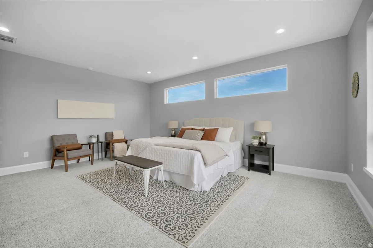 Bedroom featuring light colored carpet and recessed lighting