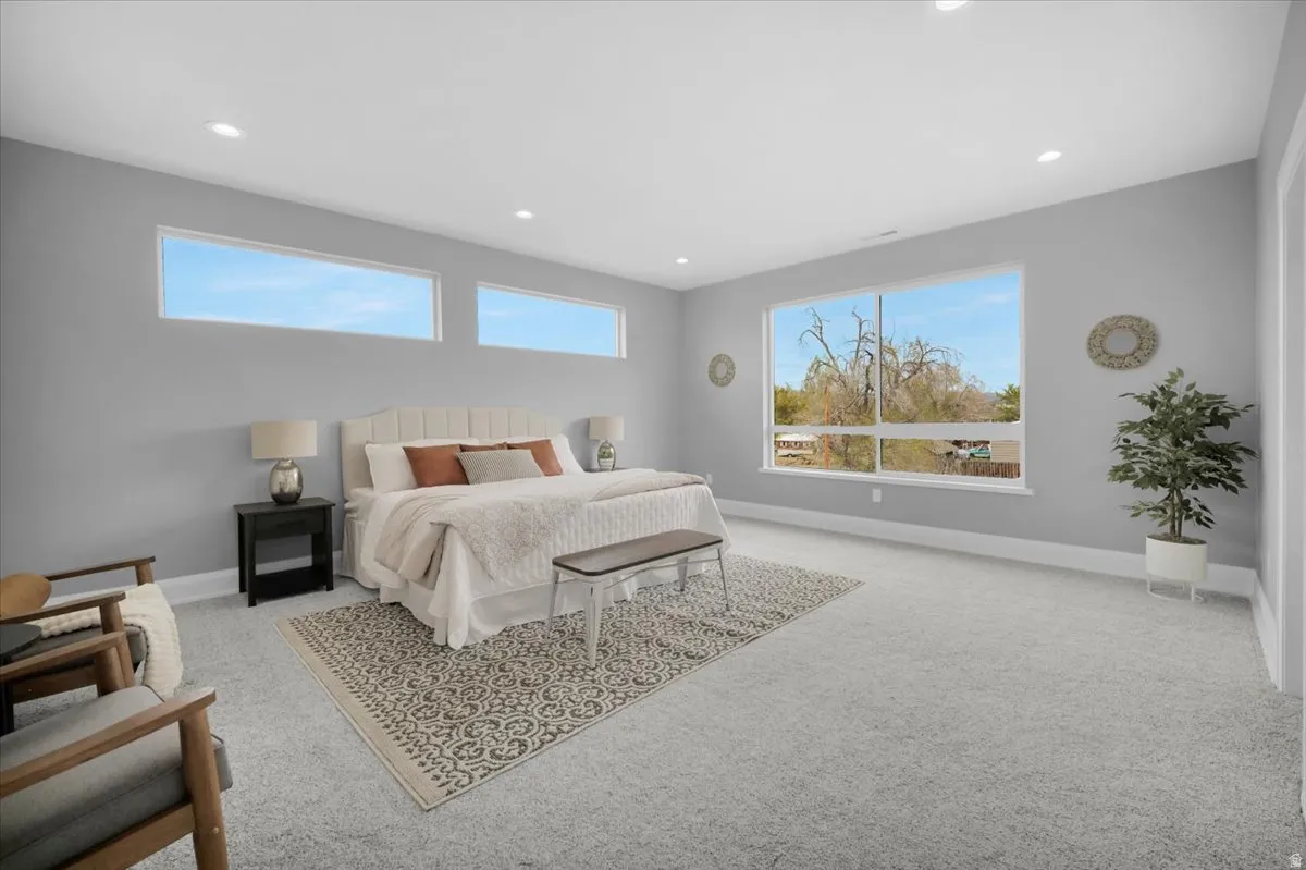 Bedroom with recessed lighting and light colored carpet