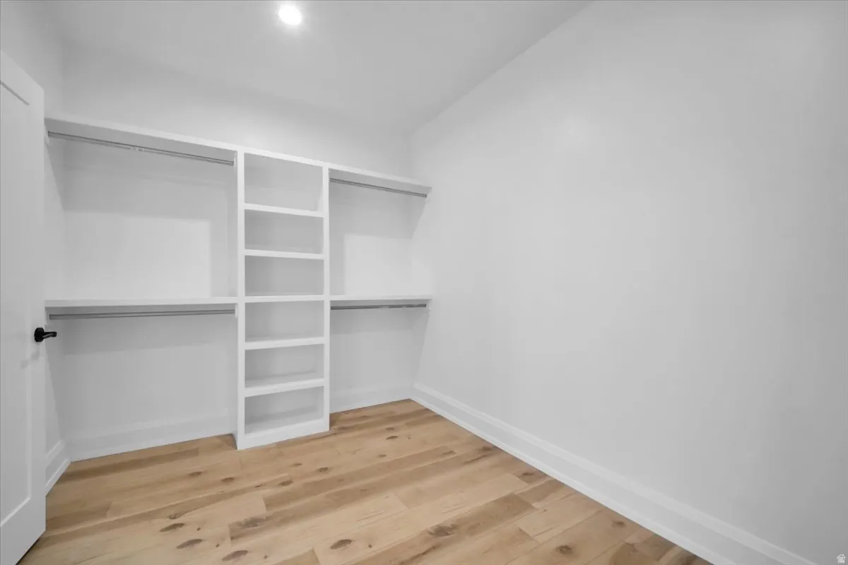 Walk in closet featuring light wood-style flooring