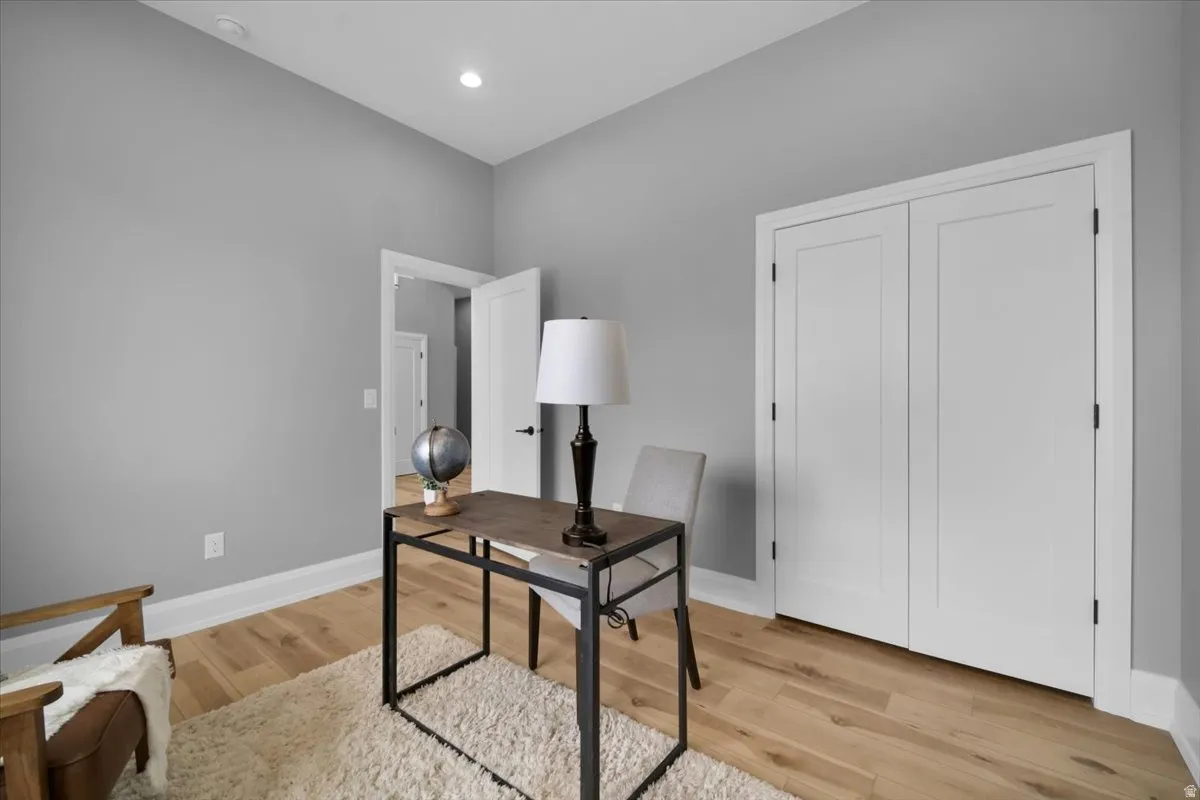 Office space featuring light wood-style flooring and recessed lighting