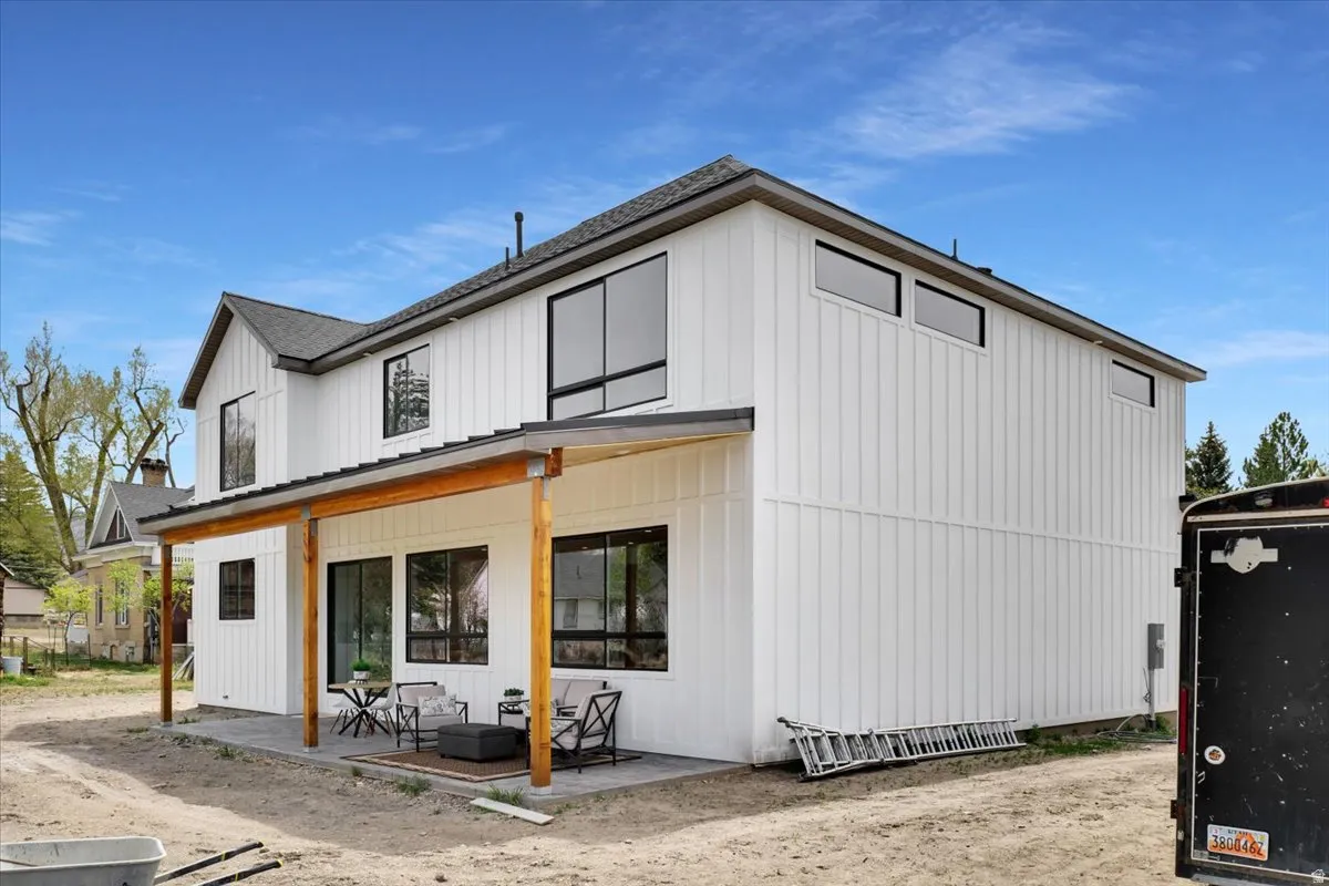 Rear view of house featuring a porch and board and batten siding