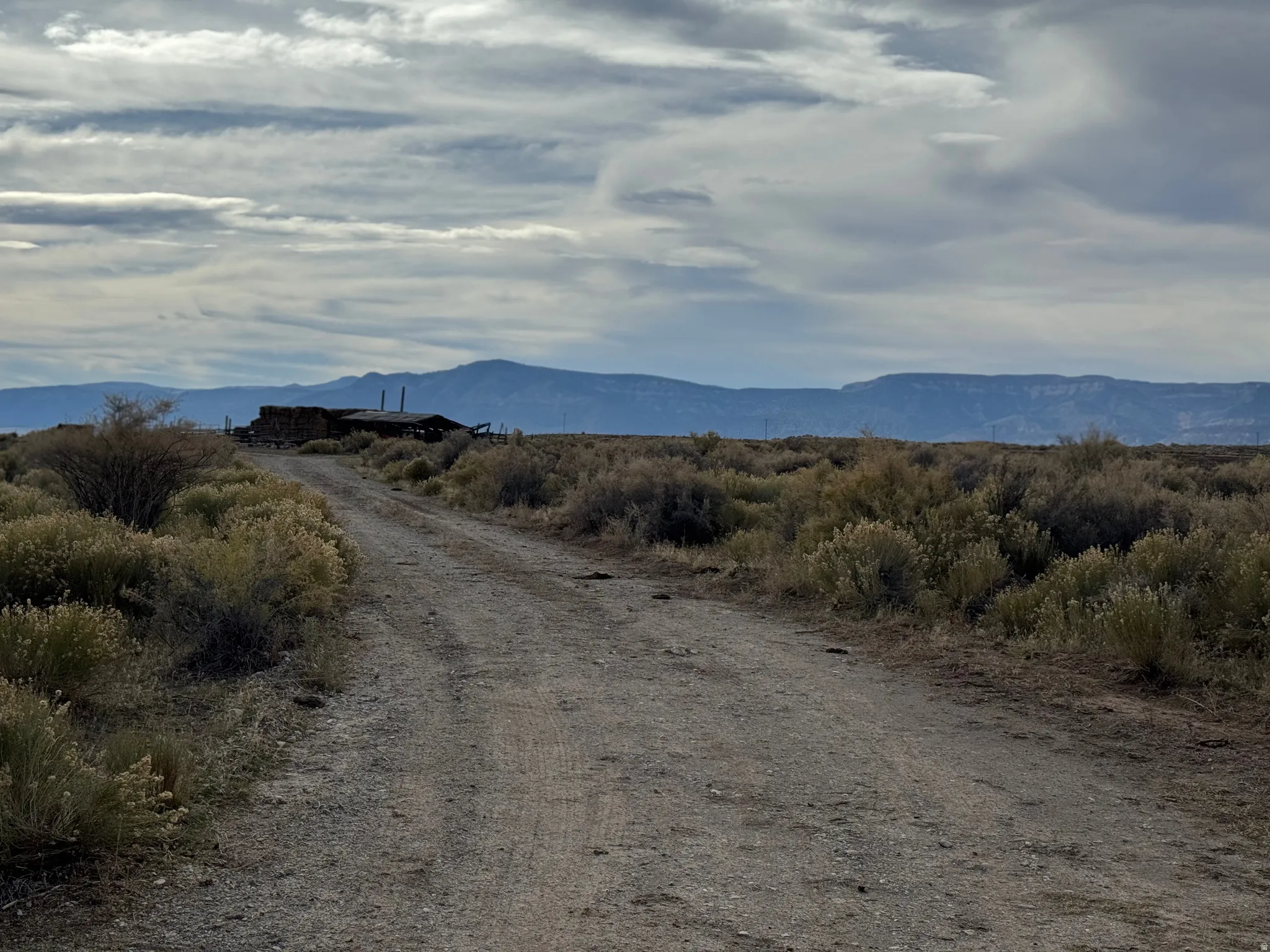 View of mountain backdrop with rural landscape