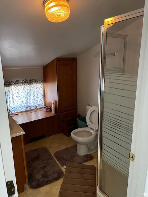 Full bathroom with vanity and a shower stall