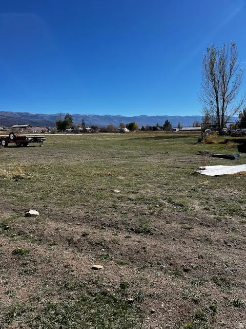 View of yard with a rural view and a mountain view