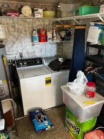 Laundry area featuring separate washer and dryer and water heater