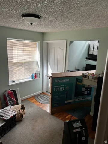 Bedroom featuring wood finished floors and a textured ceiling
