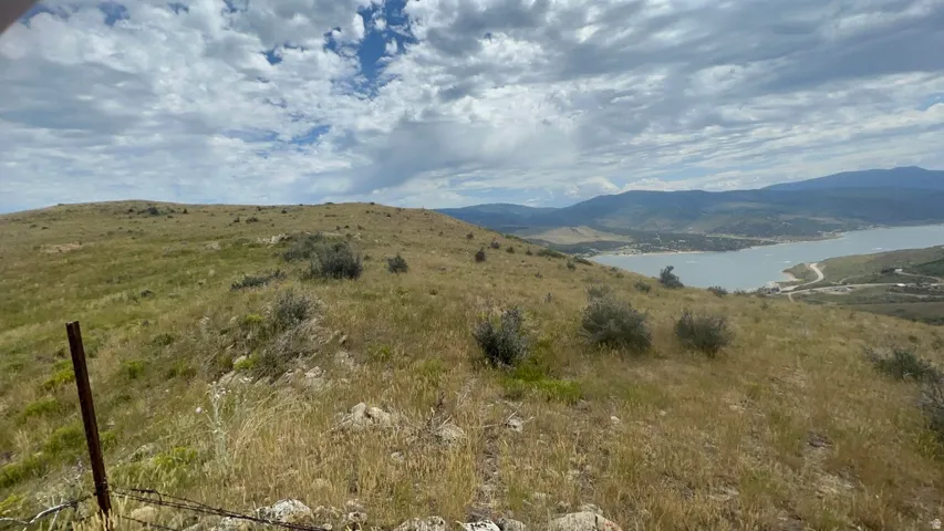 View of mountain backdrop featuring a nearby body of water