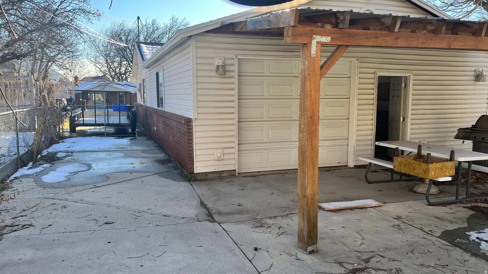 Exterior space with a  patio cover and rear garage door.