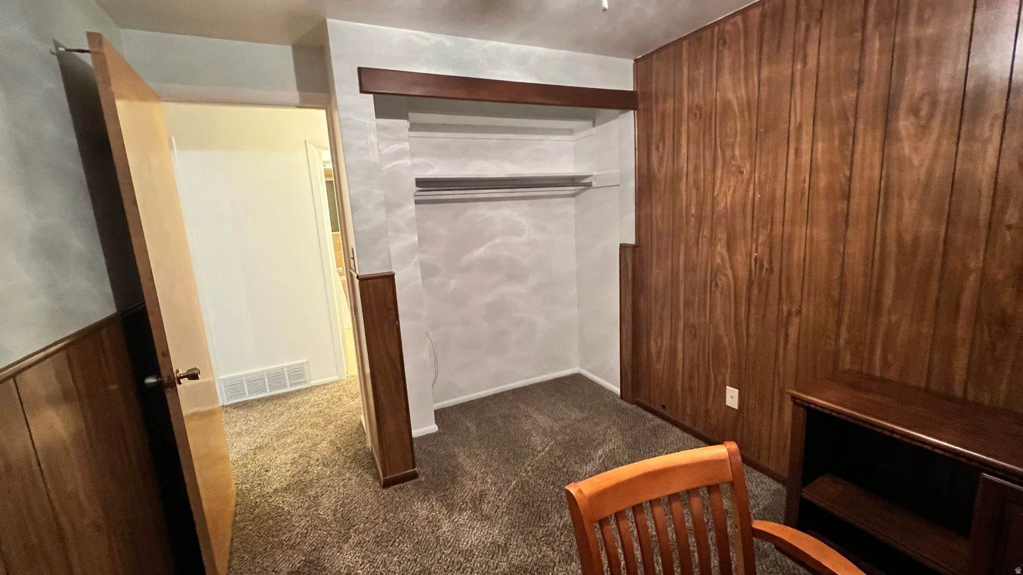 Walk in closet featuring dark carpet