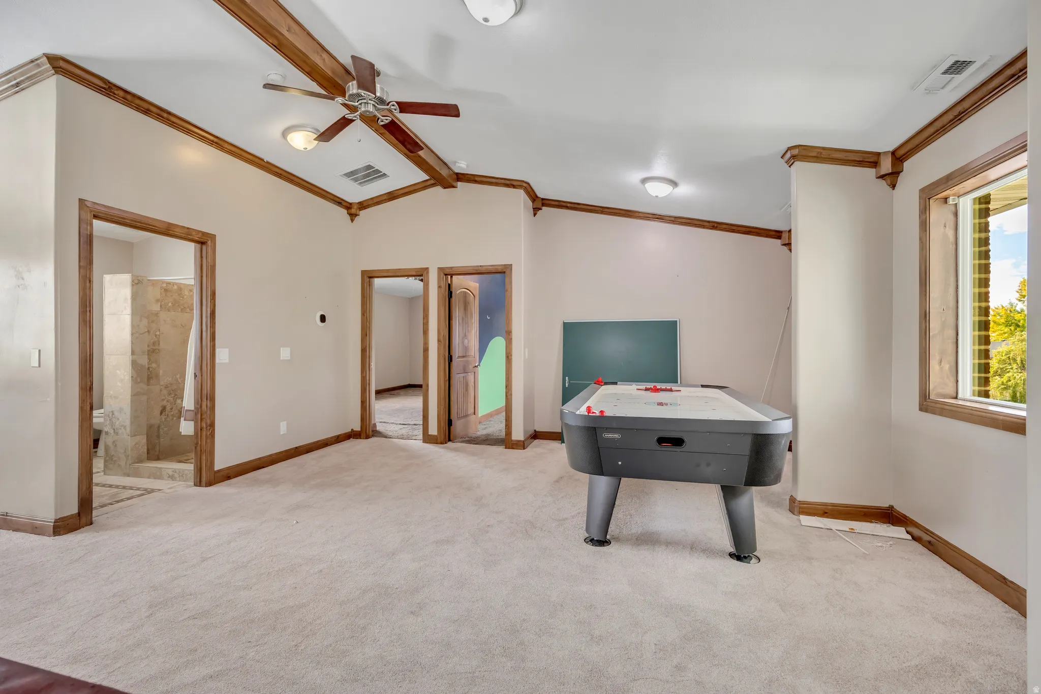 Game room with carpet flooring, crown molding, and ceiling fan