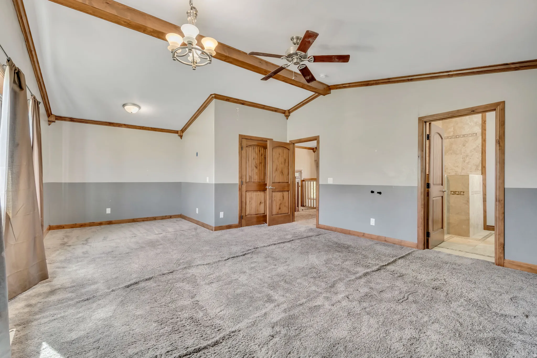 Unfurnished room with a chandelier, a ceiling fan, carpet flooring, and crown molding