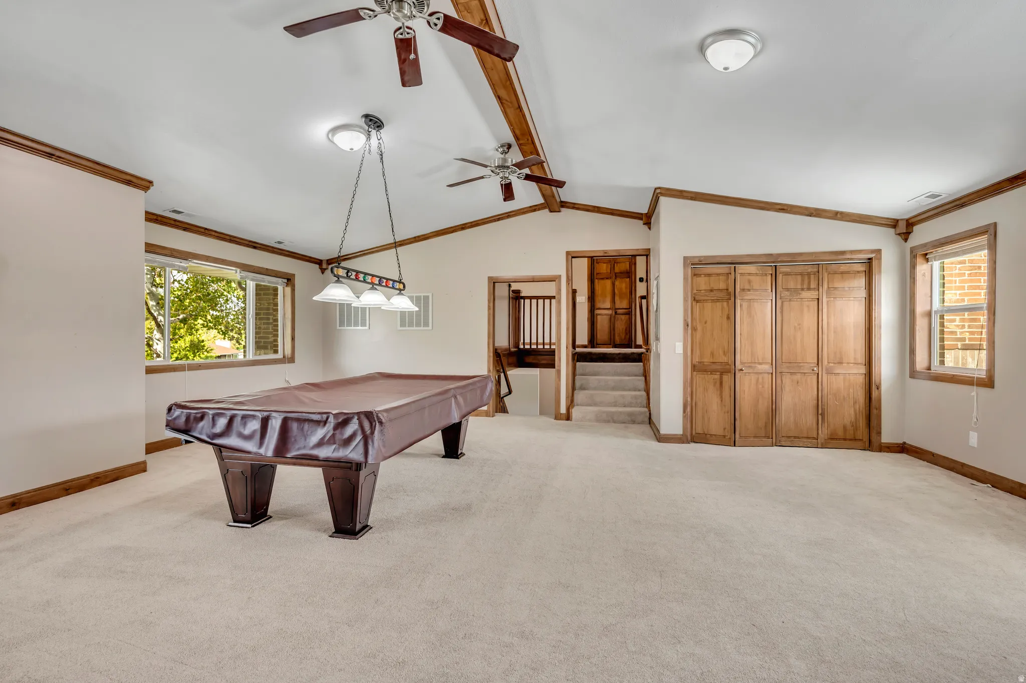 Rec room with crown molding, light carpet, billiards table, and ceiling fan