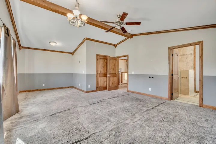 Unfurnished room with a chandelier, a ceiling fan, carpet flooring, and crown molding