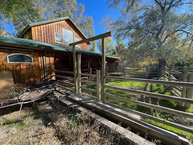View of home's exterior featuring an outbuilding, an exterior structure, a metal roof, and board and batten siding