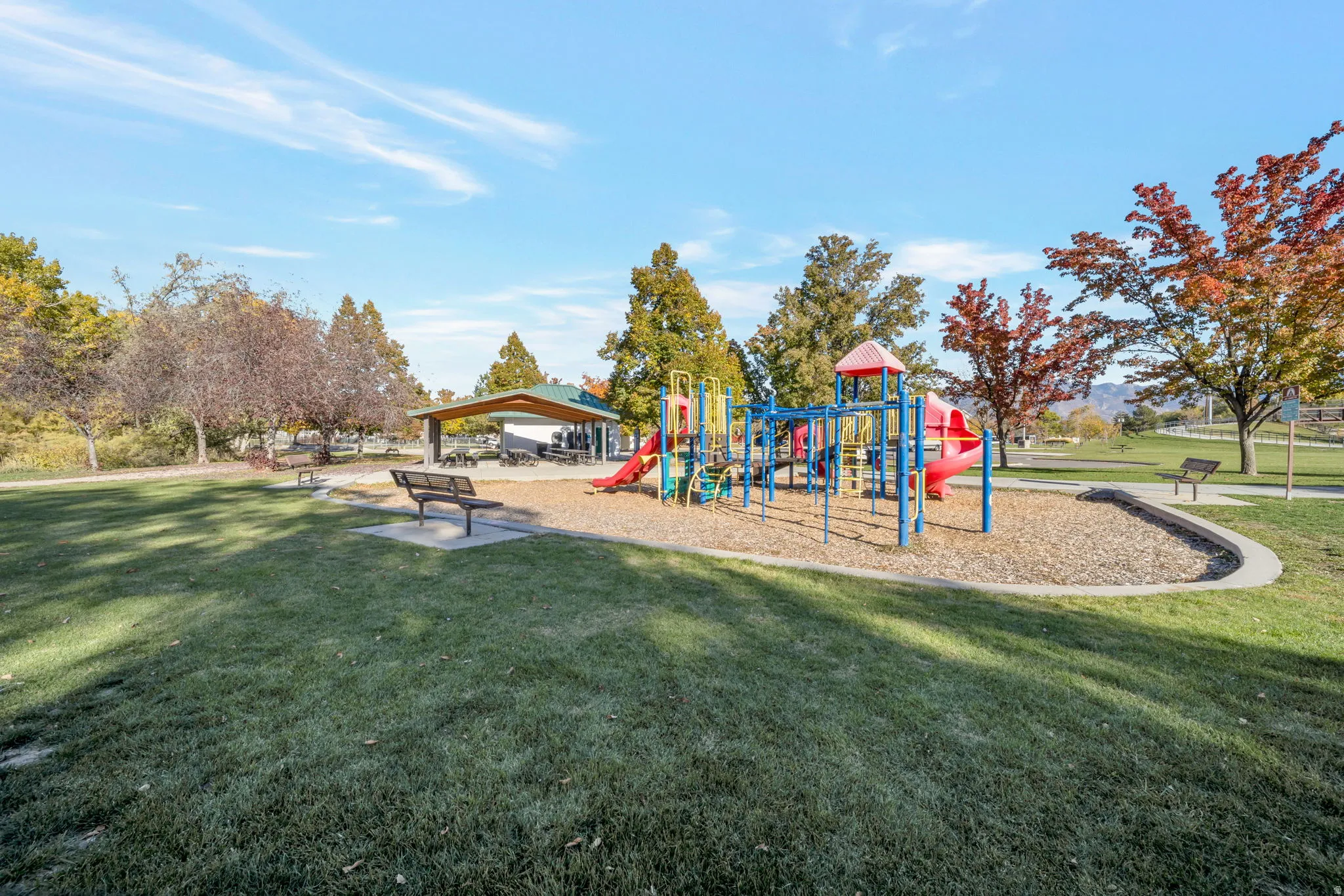 Community playground featuring a lawn and a patio