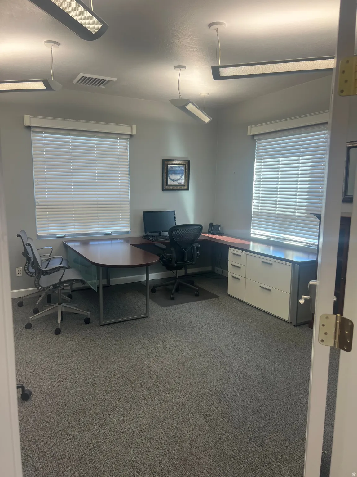 Home office featuring dark carpet