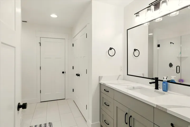 Bathroom featuring vanity, light tile patterned floors, recessed lighting, and a shower stall