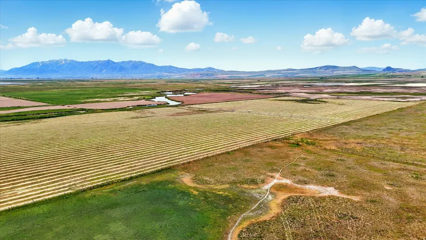 Overview of rural landscape featuring extensive farmland and mountains