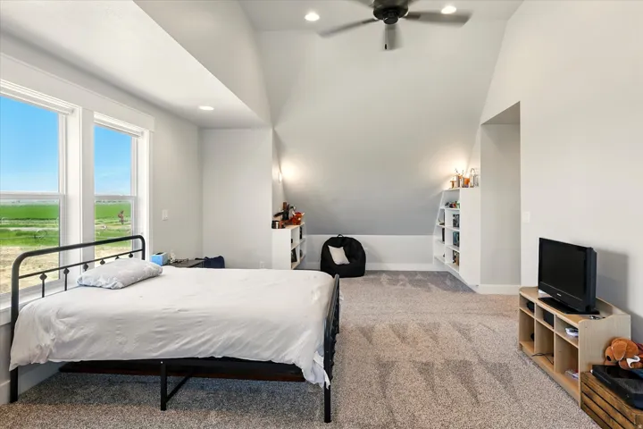 Bedroom featuring vaulted ceiling, light colored carpet, recessed lighting, and ceiling fan