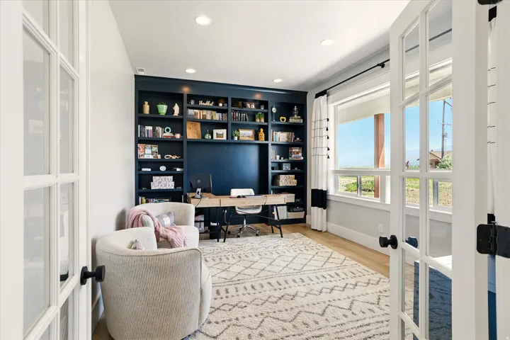 Home office with french doors, light wood-type flooring, recessed lighting, and built in features