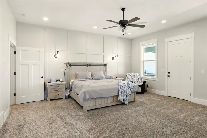 Carpeted bedroom featuring recessed lighting and a ceiling fan