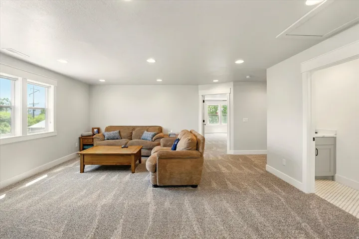 Living room with light carpet and recessed lighting