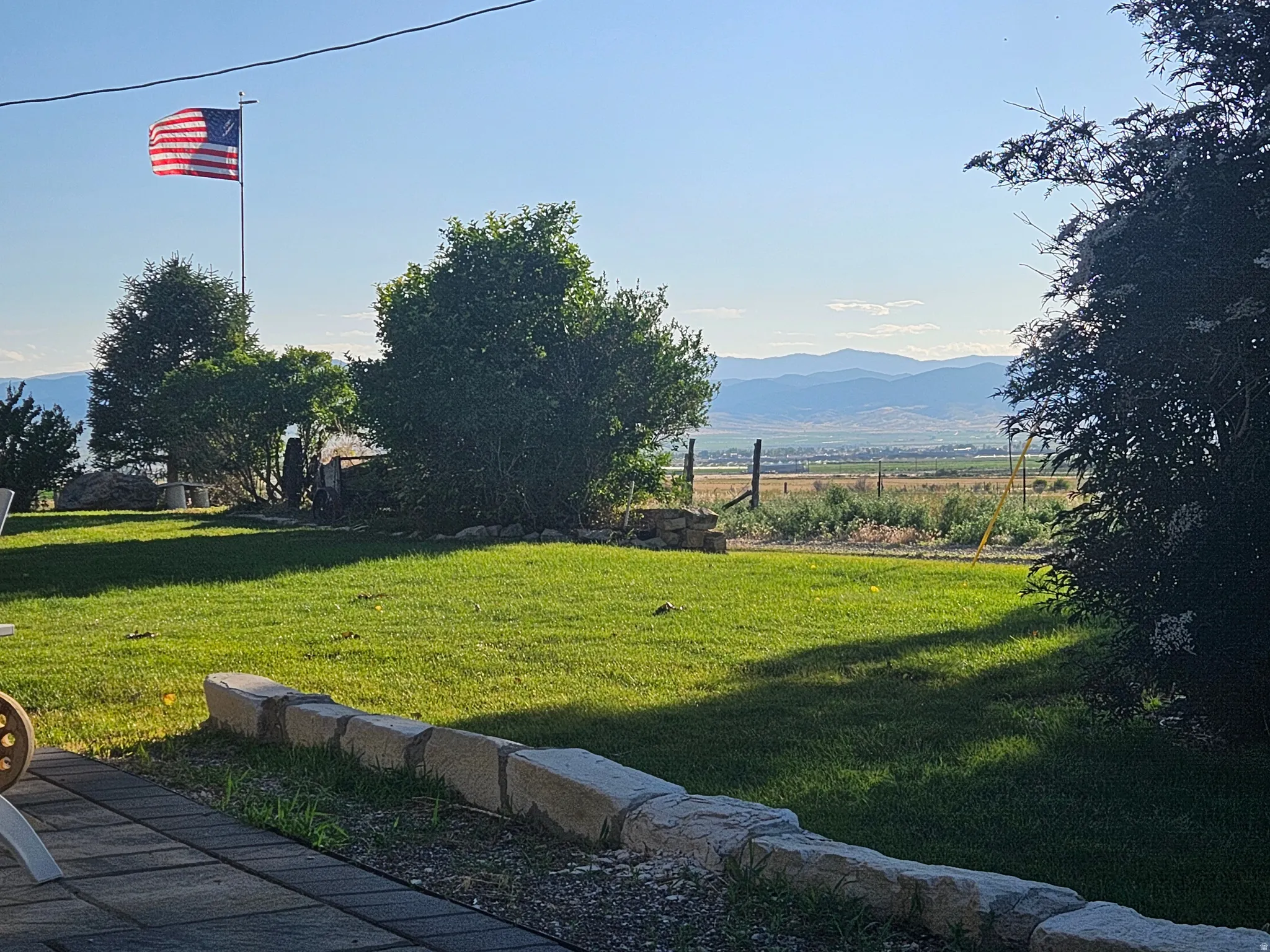 View of green lawn featuring a mountain view and a view of countryside