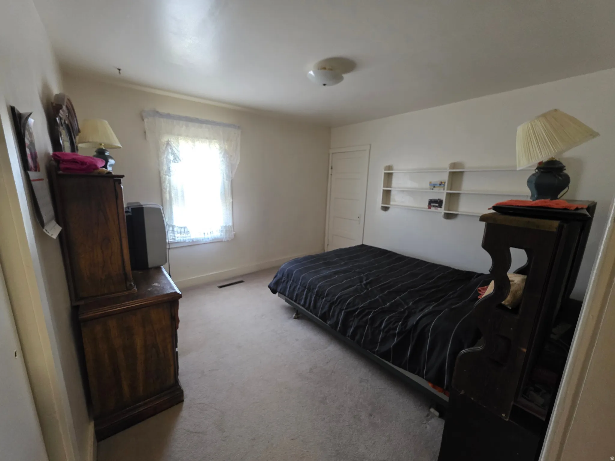Bedroom featuring light colored carpet and baseboards