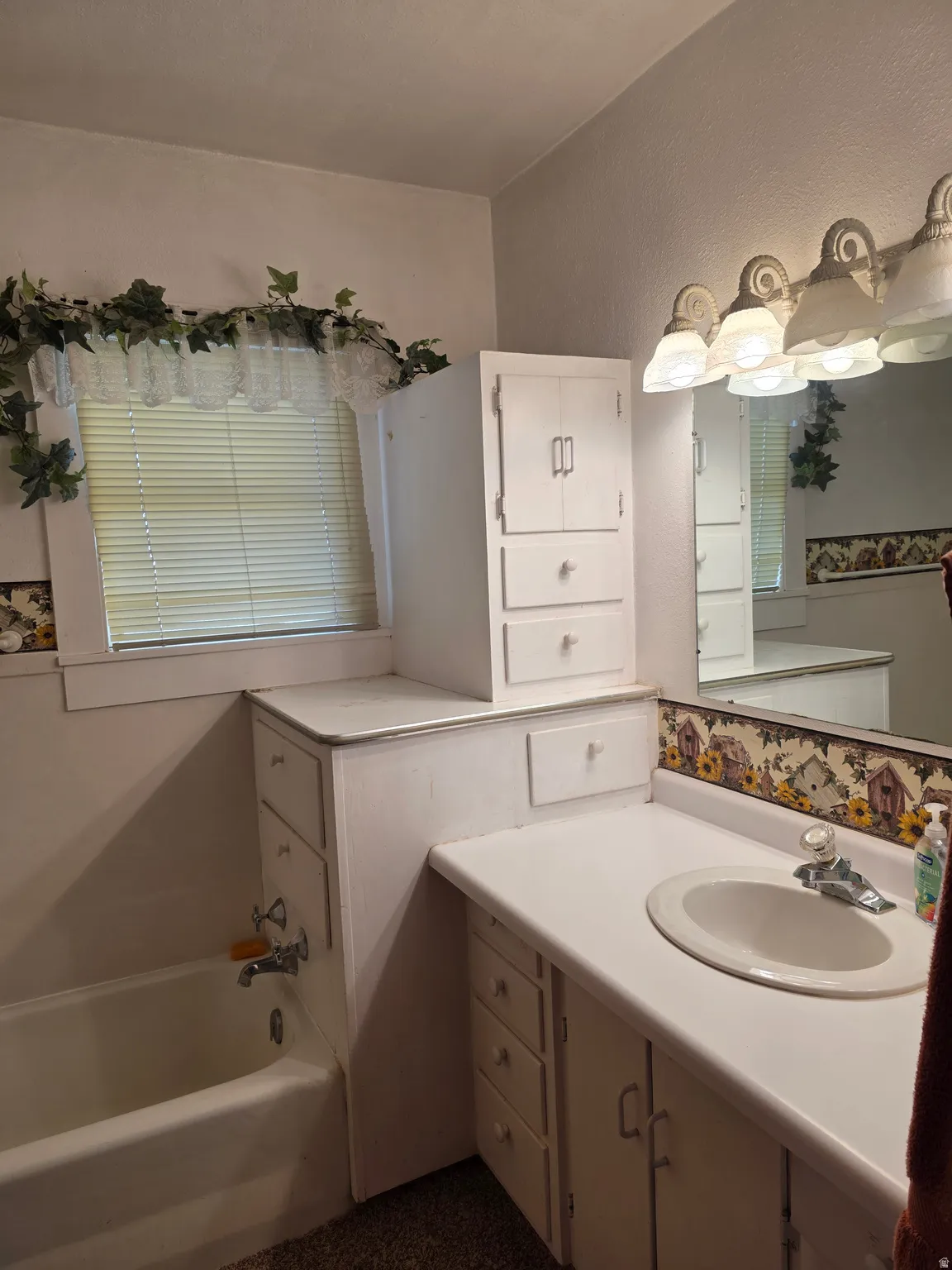 Full bathroom featuring a garden tub and vanity