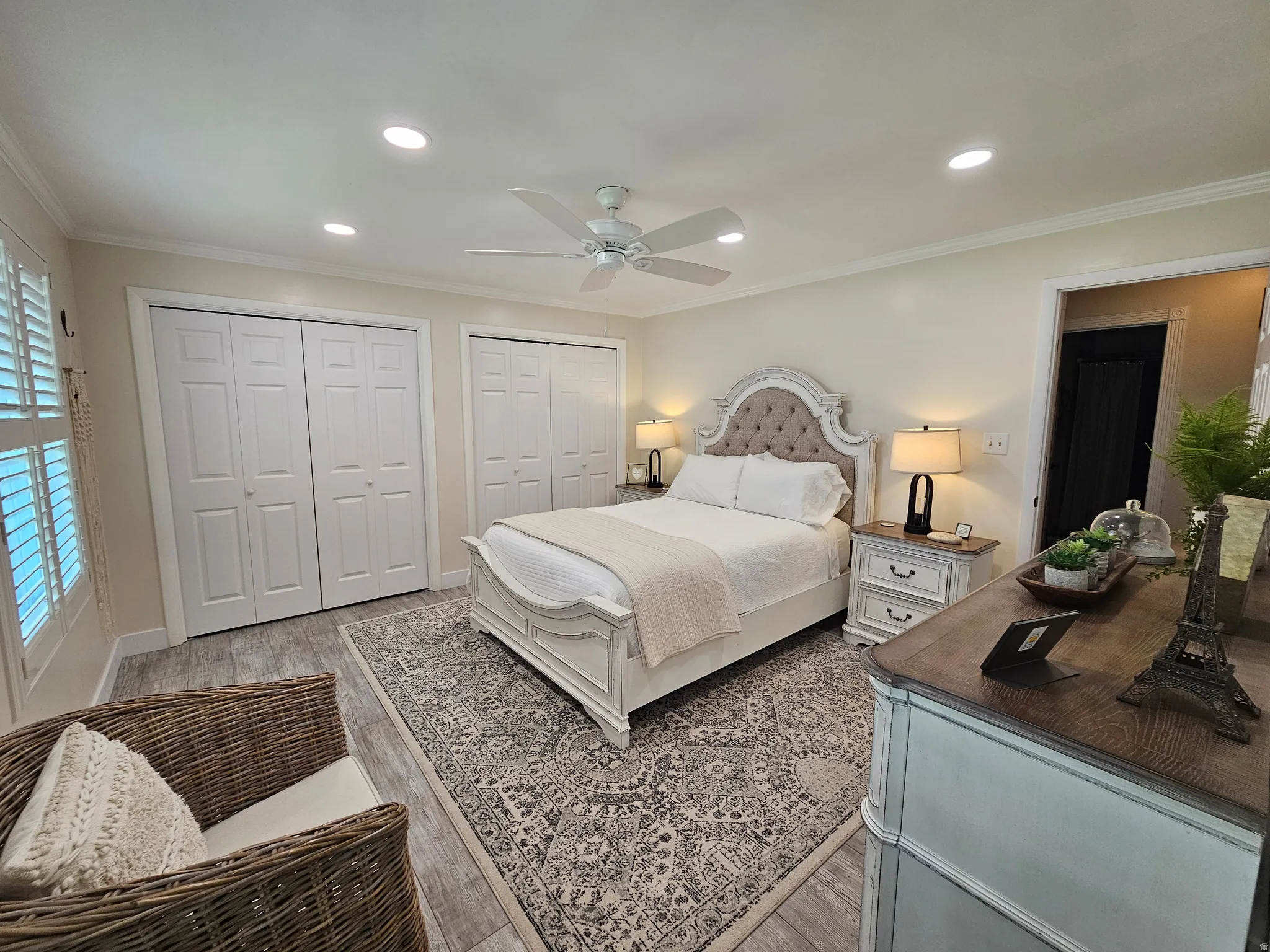 Bedroom with crown molding, multiple closets, wood finished floors, recessed lighting, and a ceiling fan
