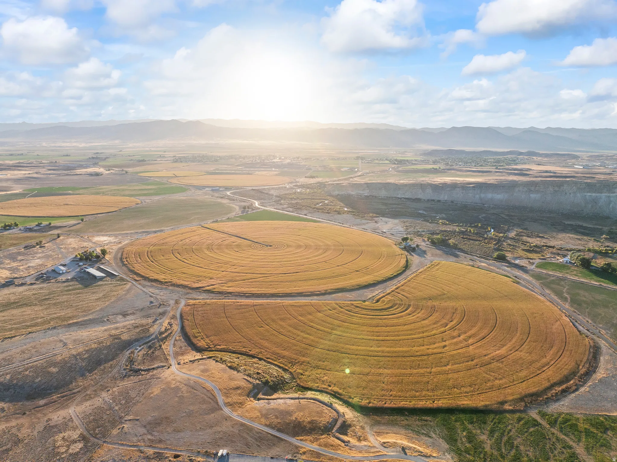 Aerial overview of property's location featuring a mountain backdrop and rural landscape