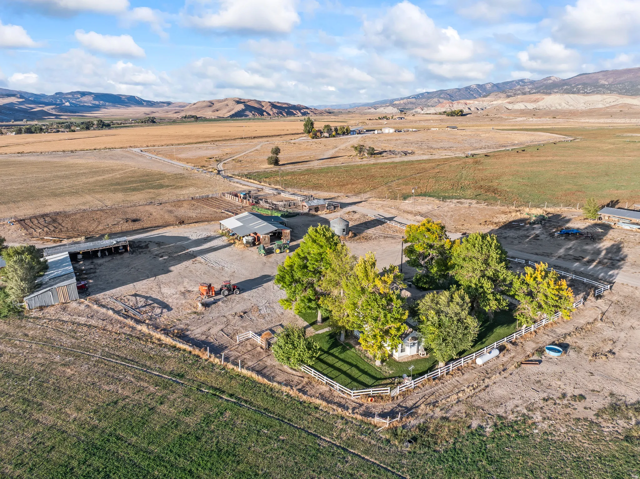Aerial view of property and surrounding area with a mountainous background and rural landscape
