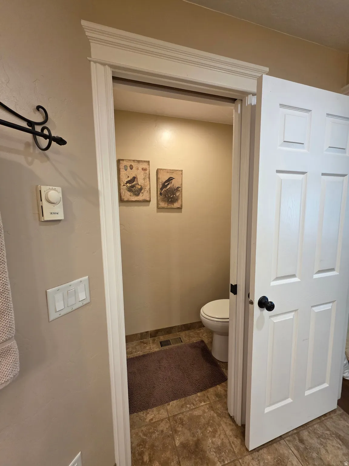 Bathroom featuring toilet and baseboards