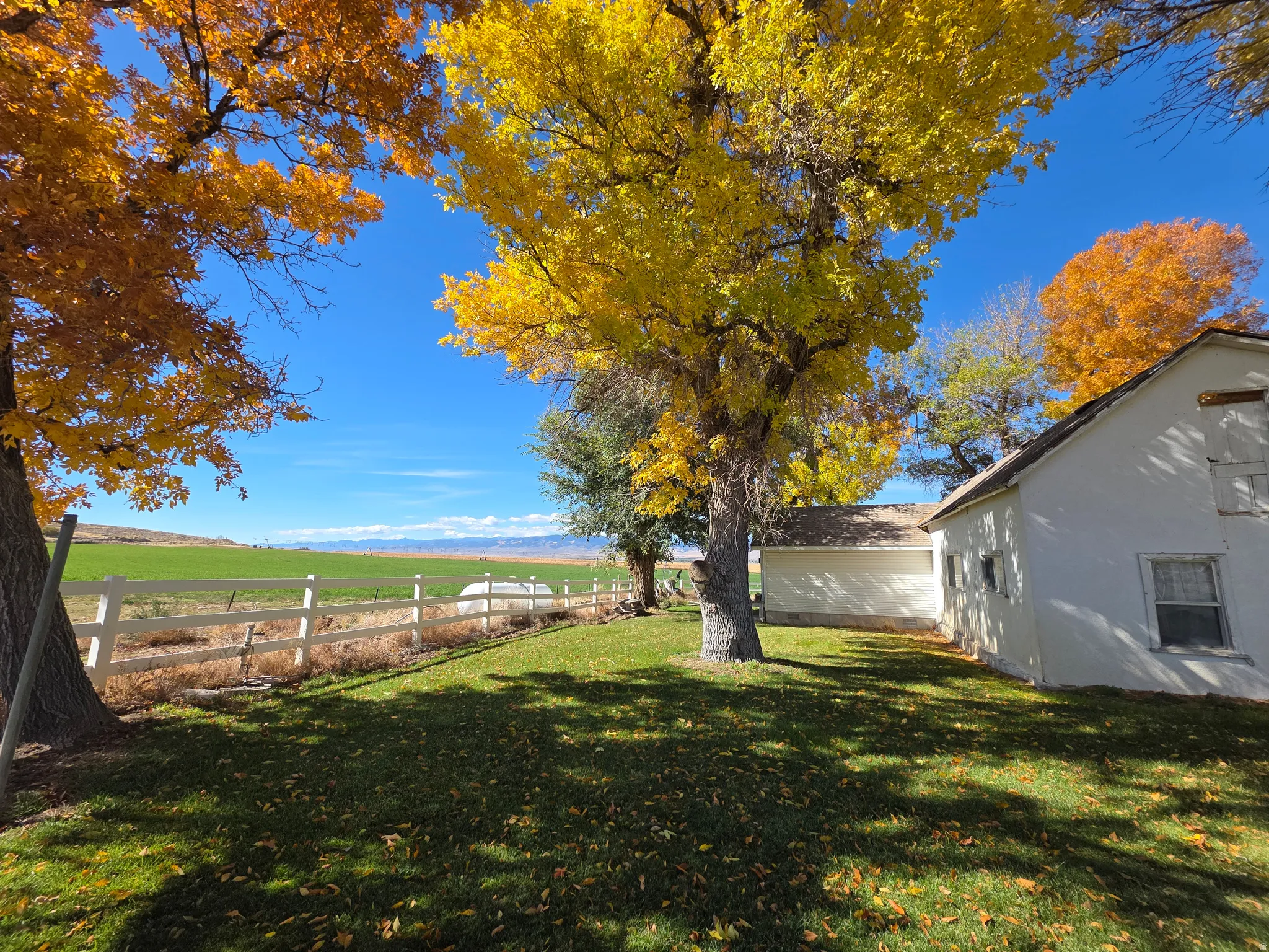 Fenced backyard featuring a rural view and a mountain view