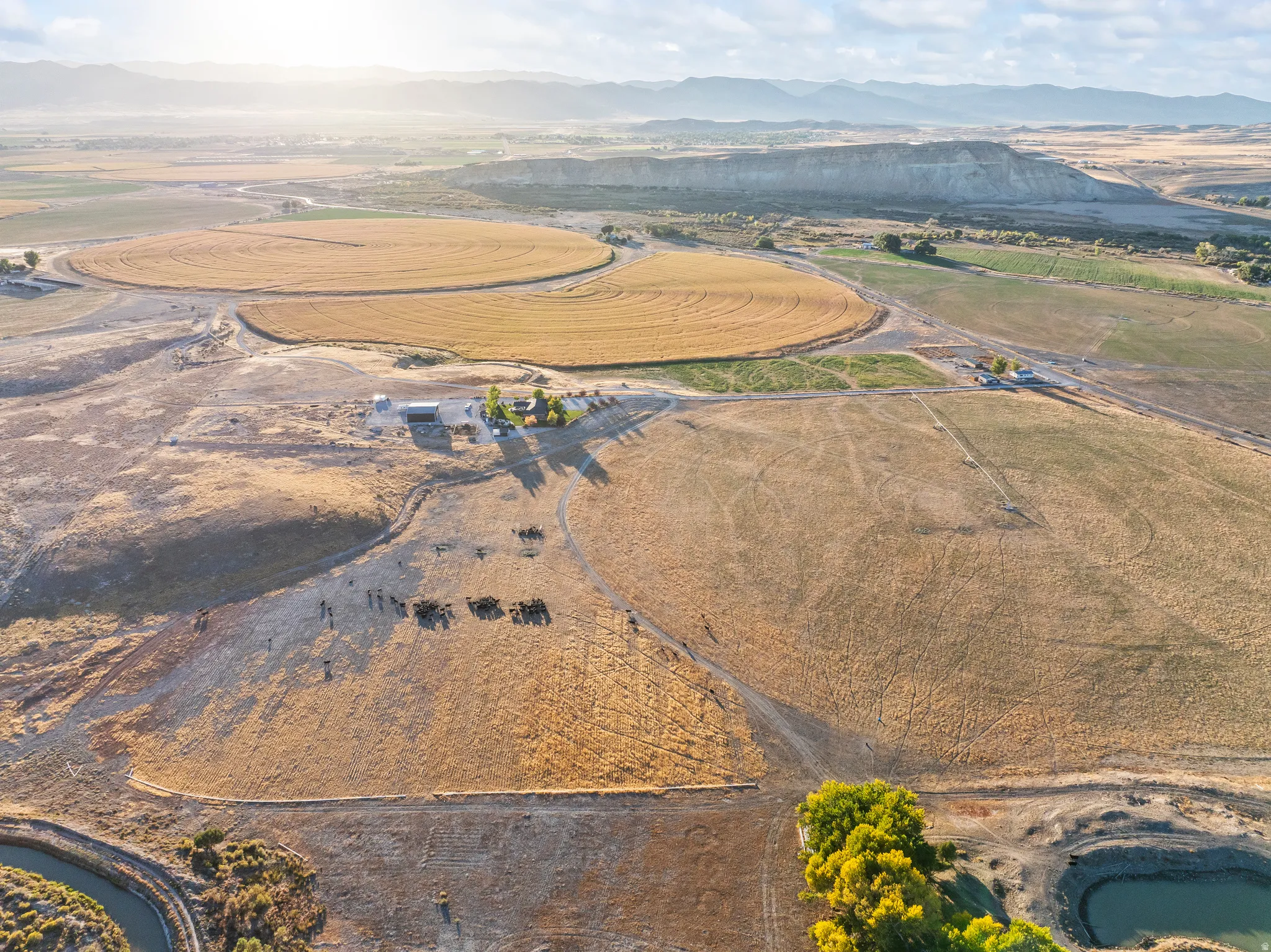 Aerial view of property and surrounding area with a mountain backdrop and rural landscape