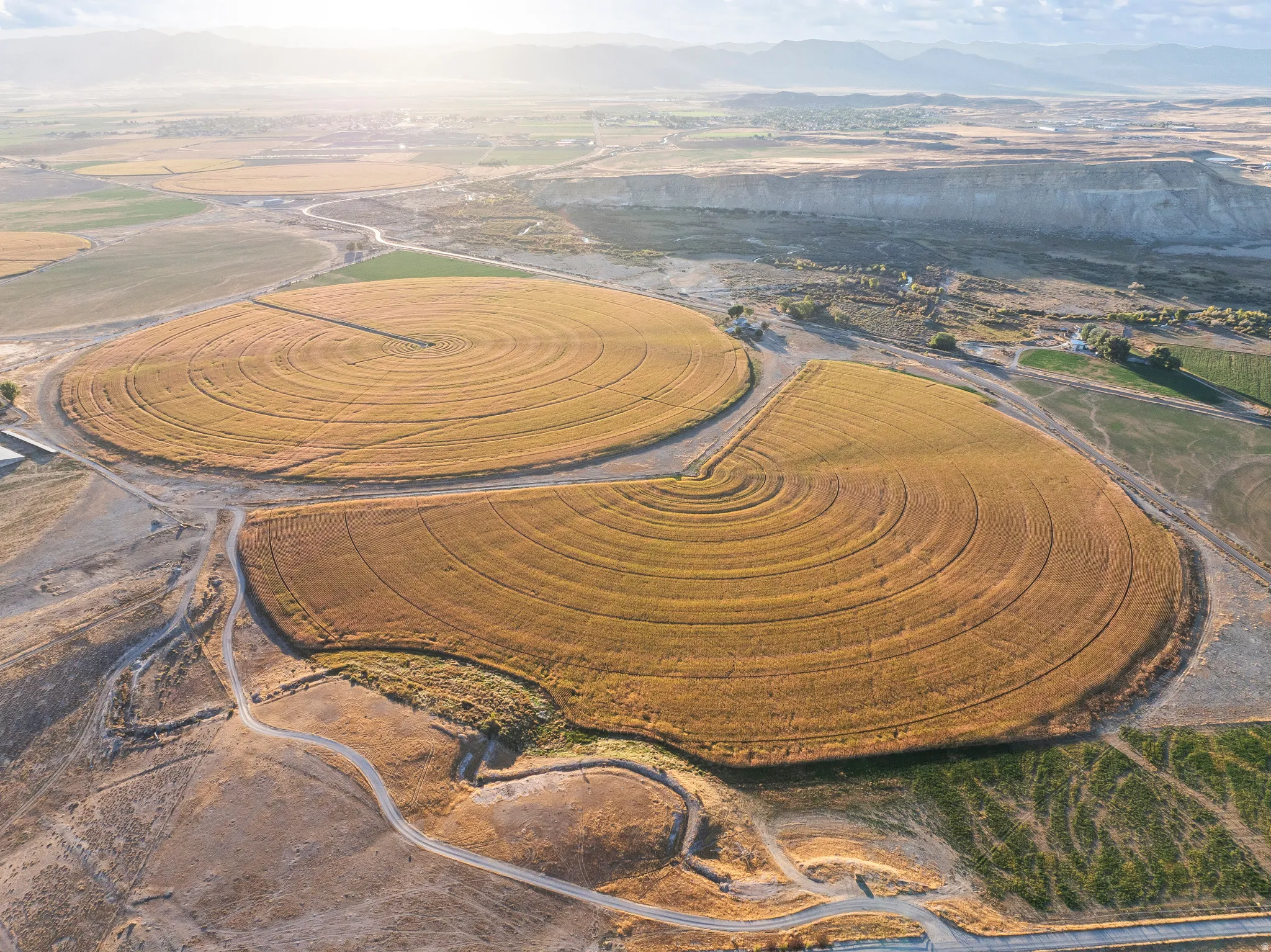 Aerial view of property and surrounding area with a mountainous background and rural landscape