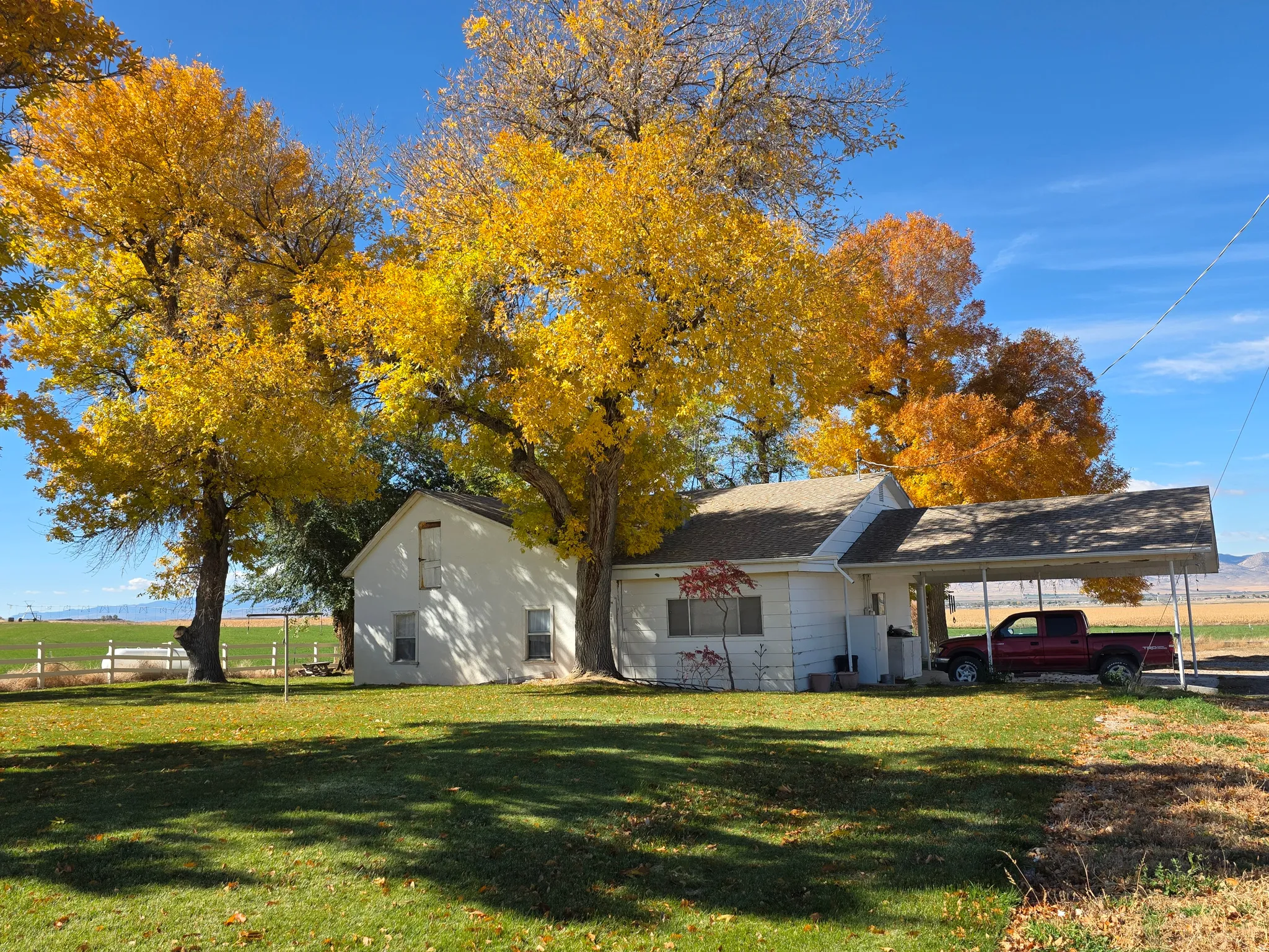 View of front of property with a front yard and an attached carport