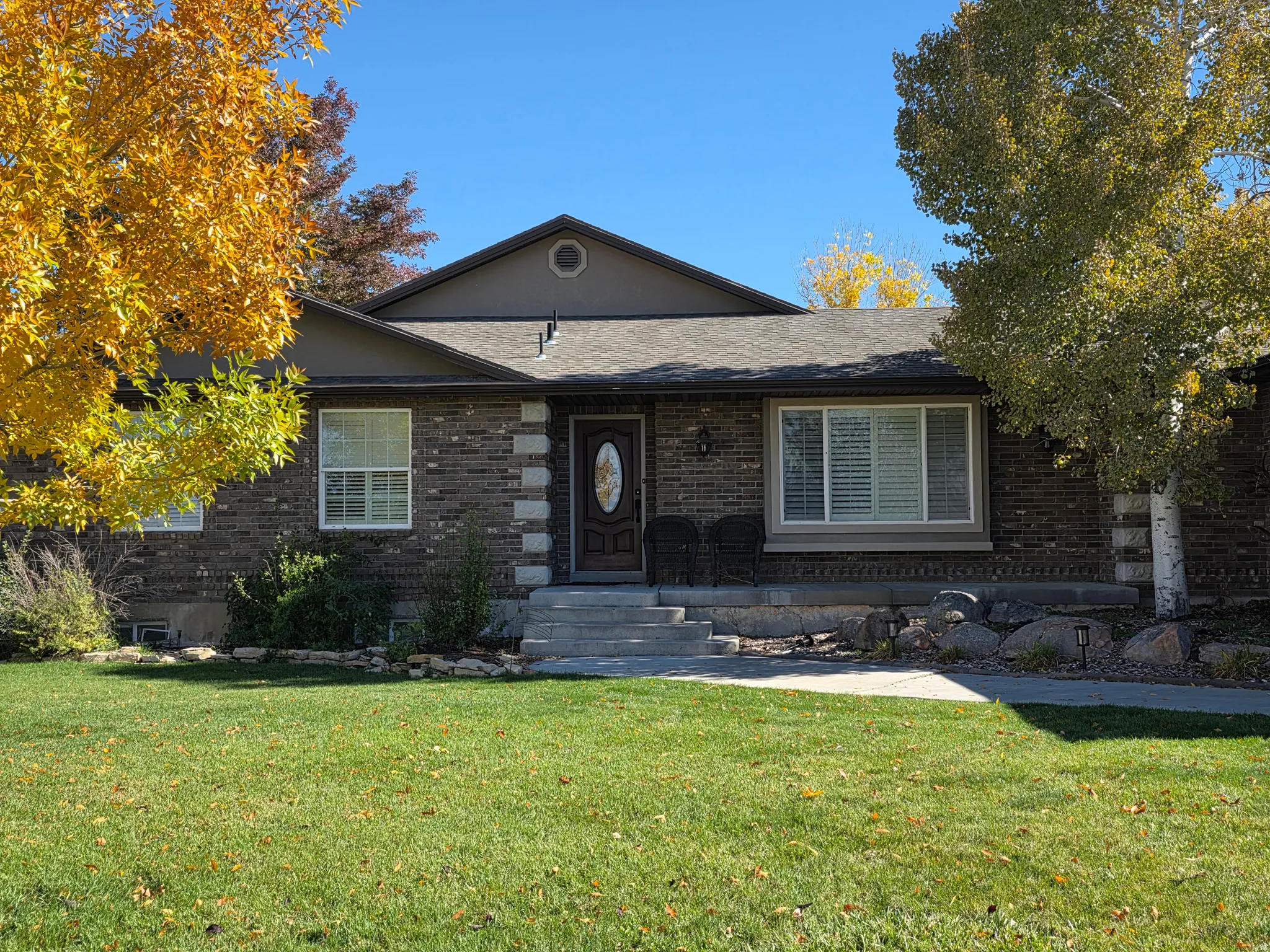 Ranch-style house with a front lawn and brick siding