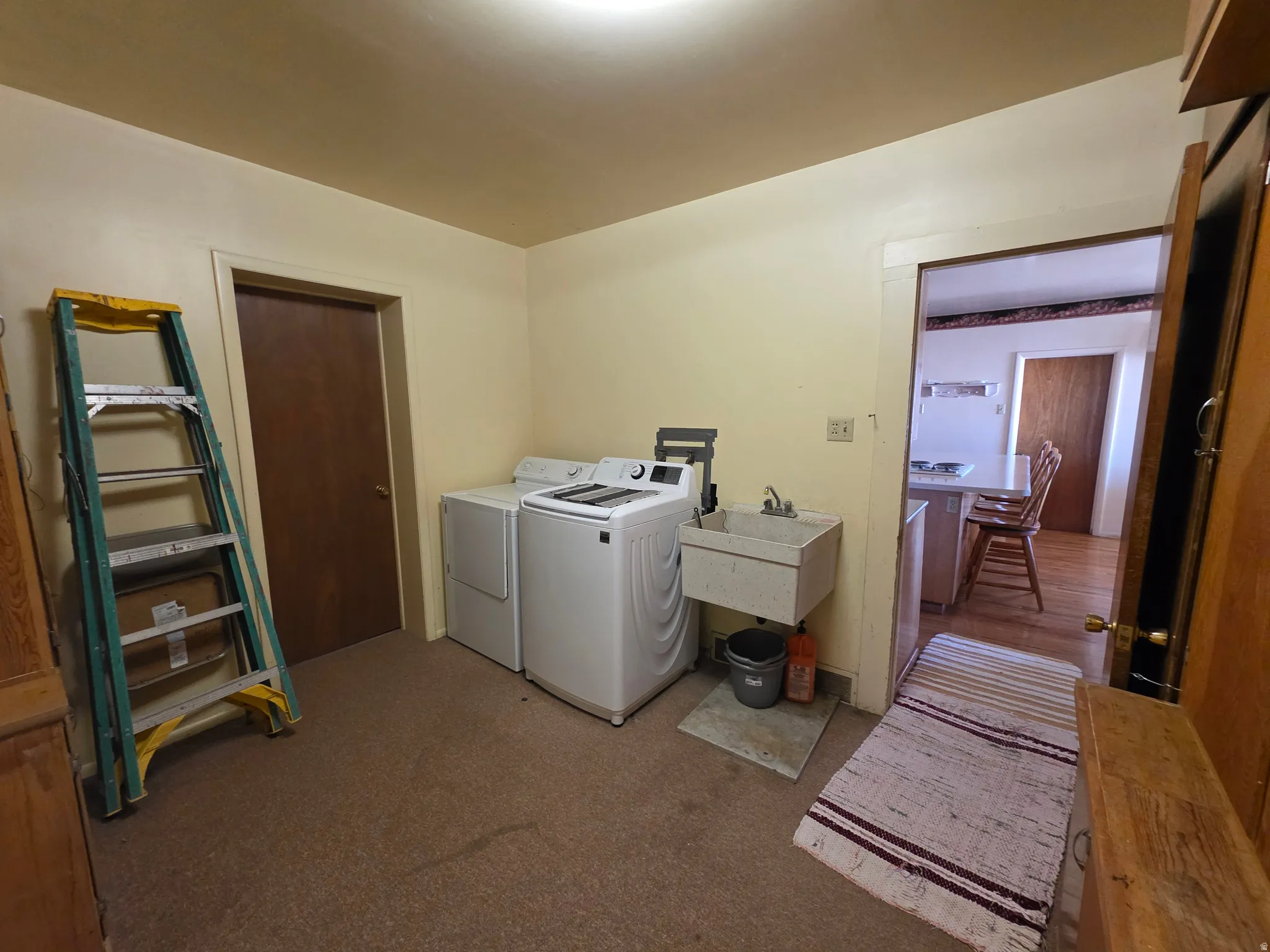 Laundry area featuring carpet floors and washing machine and dryer