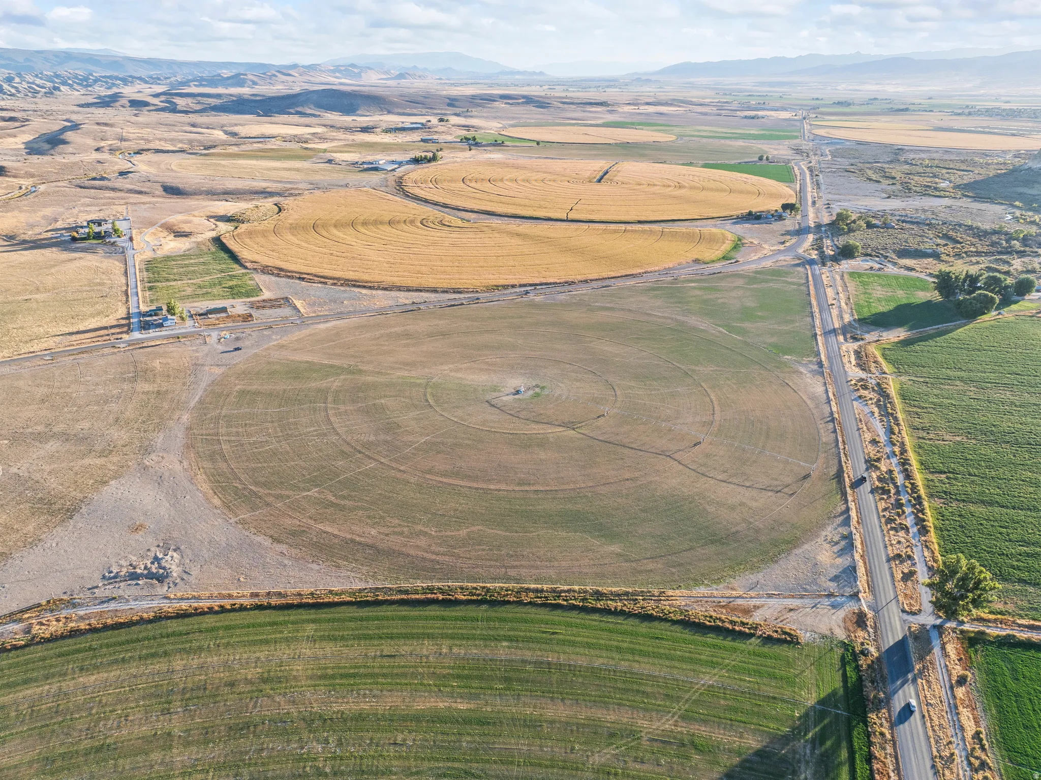 Aerial view of property and surrounding area with mountains and rural landscape