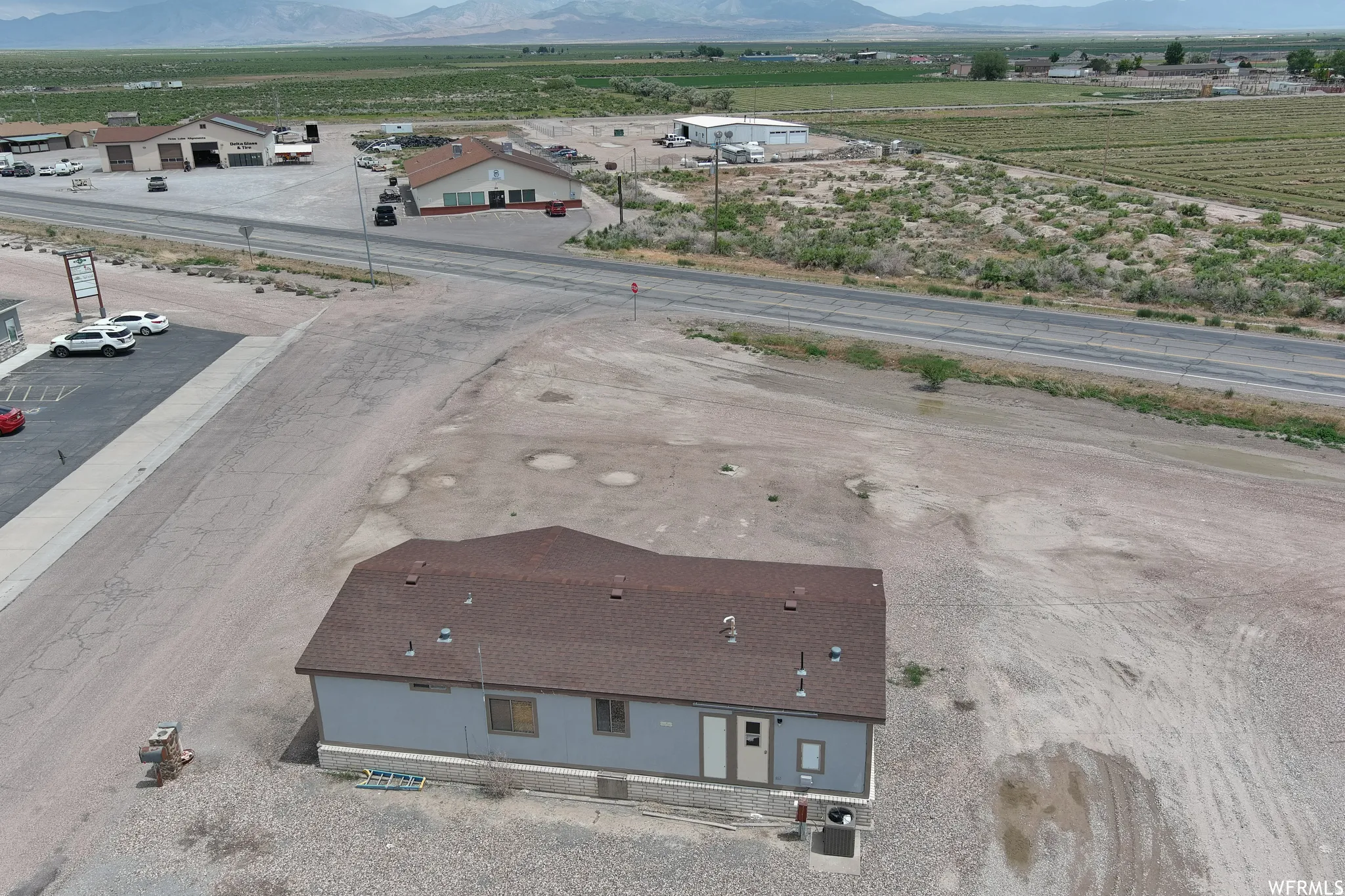 Aerial view of sparsely populated area with a mountain backdrop